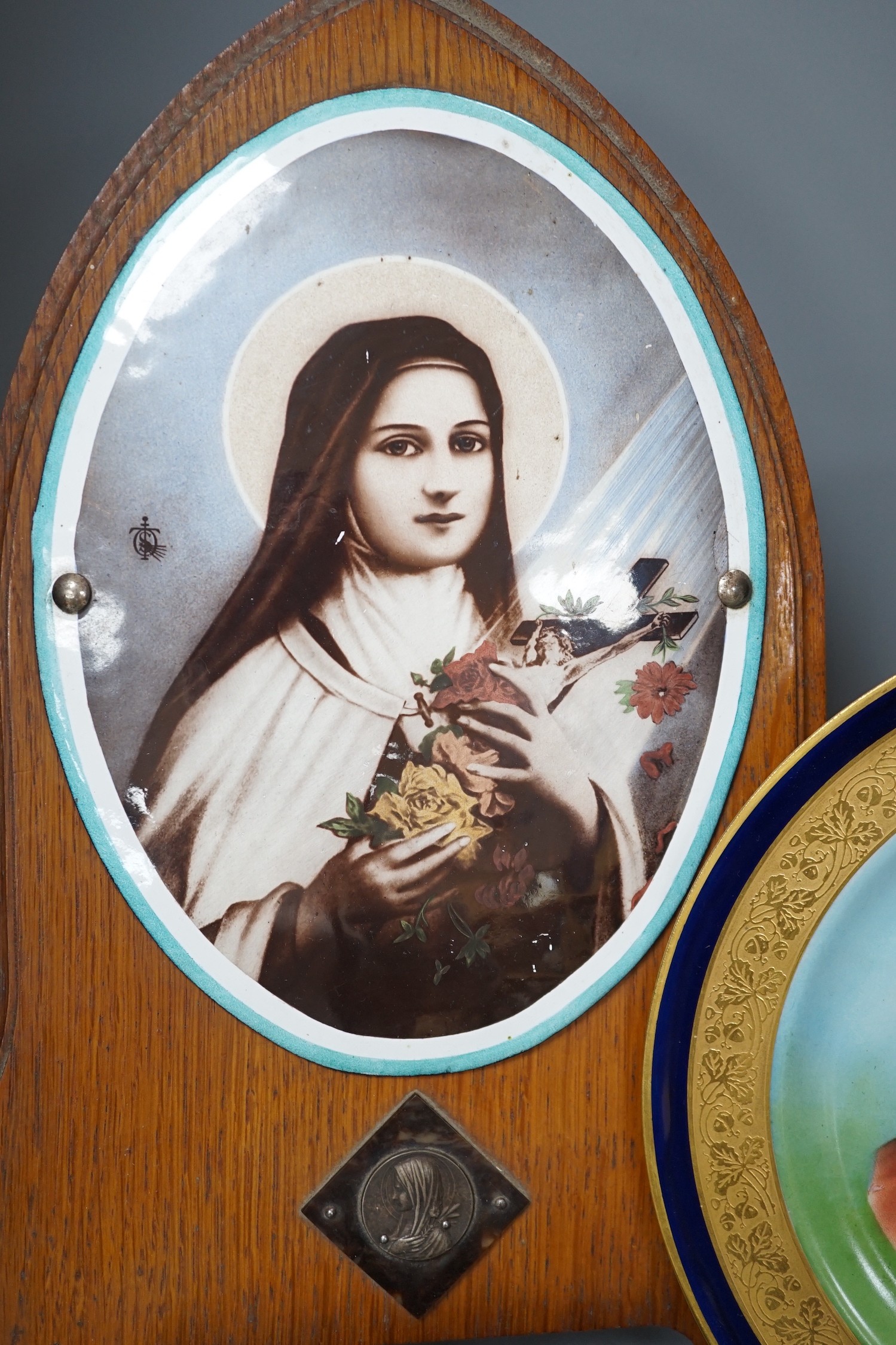 A Limoges plate and cast bronze portrait of Christ with crown of thorns and a framed plaque of the Madonna, frame 37 cms high